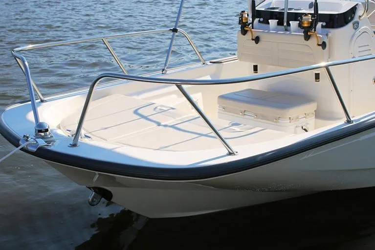 Slide: The Image of Manufacturer Provided Image: 2026 Boston Whaler 150 Montauk boat on water, showcasing sleek design and spacious deck. - 7