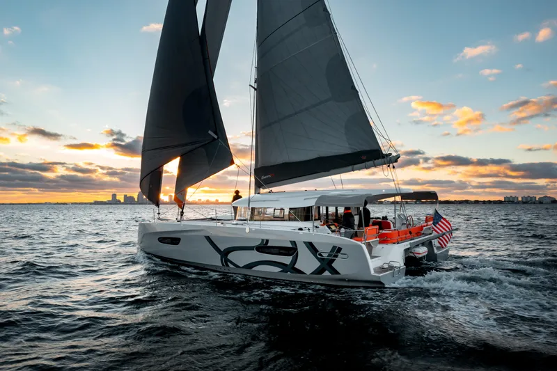 Slide: The Image of Sailing yacht Excess 14, 2026 model, cruising at sunset on open water. - 13