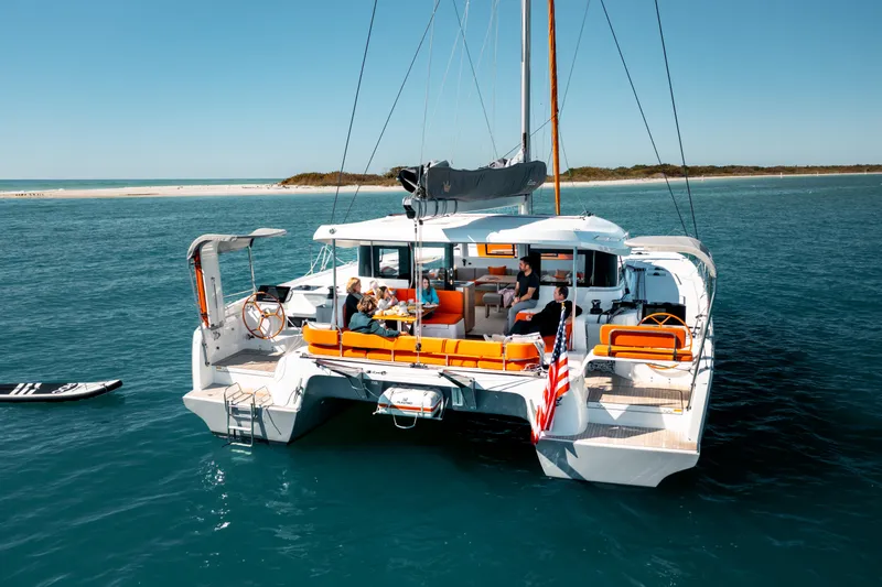 Slide: The Image of Luxury Excess 14 catamaran sailing in clear waters, 2026 model, with passengers enjoying the deck. - 20