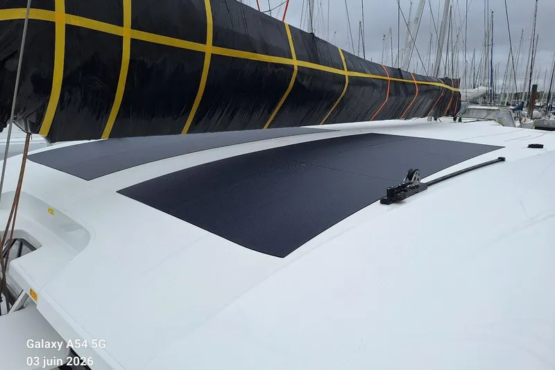 Slide: The Image of Sleek 2026 Excess 14 yacht with solar panels on deck, docked in a marina. - 33