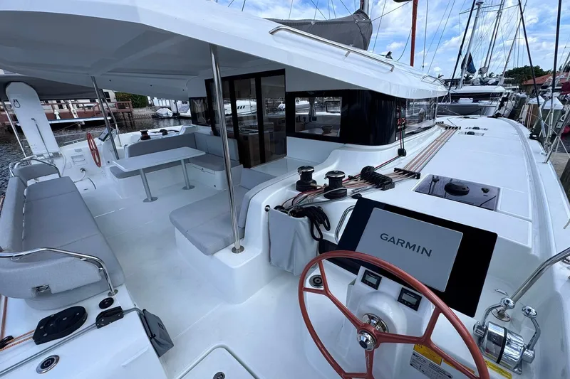 Slide: The Image of Modern 2026 Excess 14 catamaran with spacious deck, seating, and Garmin navigation system. - 40