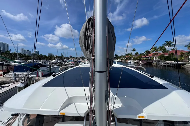 Slide: The Image of Modern Excess 14 catamaran docked at marina, 2026 model, under clear blue sky. - 41