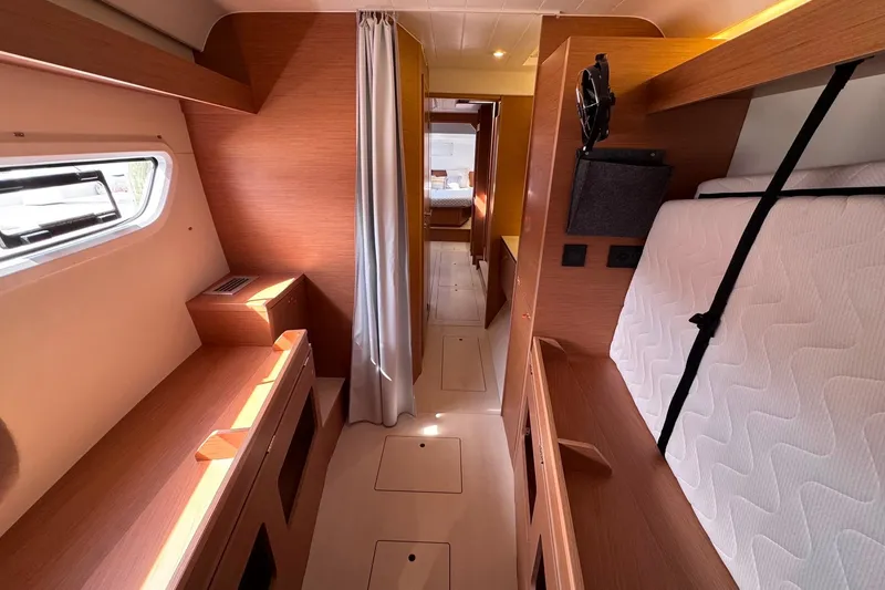 Slide: The Image of Interior of 2026 Excess 14 yacht with modern wood finish and cozy sleeping area. - 63