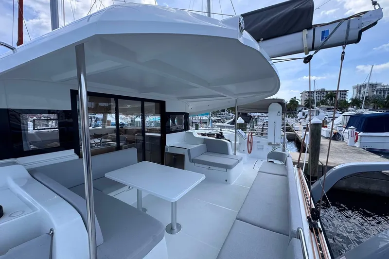 Slide: The Image of Modern 2026 Excess 14 catamaran with spacious deck and seating at marina. - 42