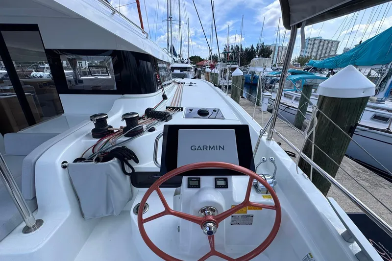Slide: The Image of Cockpit view of 2026 Excess 14 yacht with Garmin navigation system at marina. - 44
