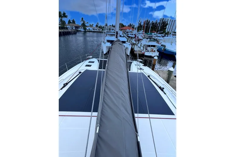 Slide: The Image of 2026 Excess 14 yacht docked at marina, showcasing sleek design and solar panels. - 35