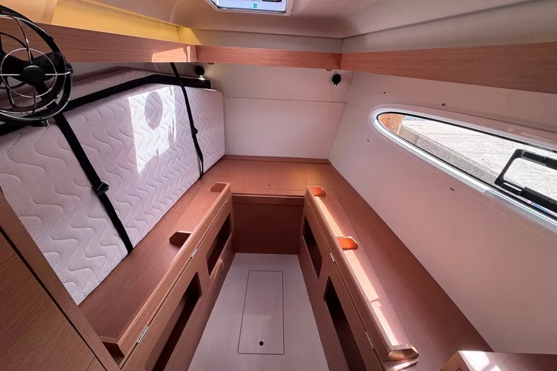 Slide: The Image of Interior of 2026 Excess 14 sailboat cabin with wooden finish and mattress. - 70