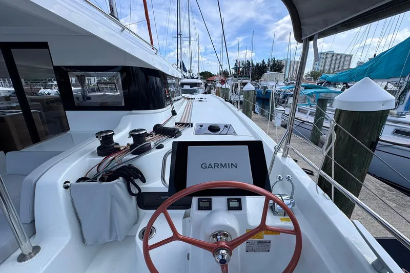 Slide: The Image of Modern Excess 14 sailboat cockpit with Garmin navigation, docked at marina, 2026 model. - 38