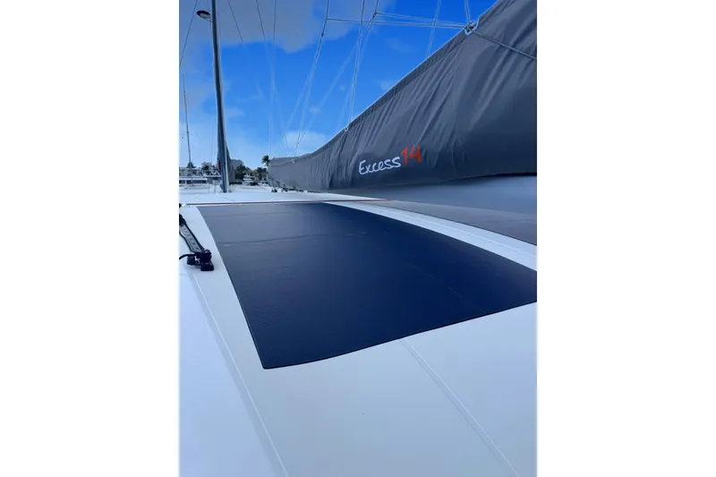 Slide: The Image of Sleek 2026 Excess 14 sailboat with modern design and visible branding on sail cover. - 34