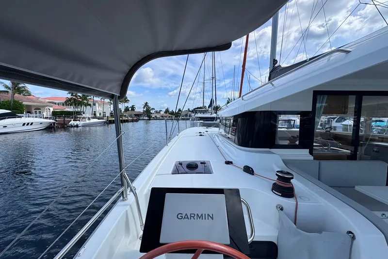 Slide: The Image of 2026 Excess 14 yacht with Garmin navigation, docked in a scenic marina. - 36