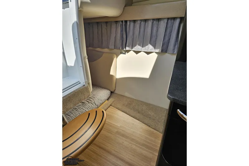 Slide: The Image of Interior of a 2015 Formula 350 Sun Sport boat, featuring cozy seating and elegant wood flooring. - 100