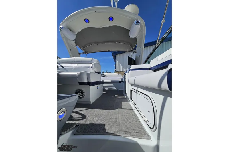 Slide: The Image of 2015 Formula 350 Sun Sport boat interior with seating and canopy under clear blue sky. - 106