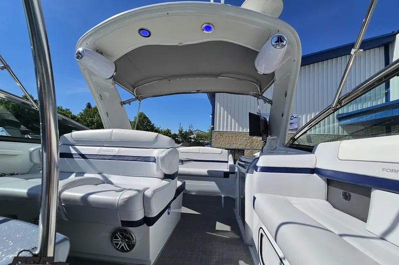 Slide: The Image of 2015 Formula 350 Sun Sport boat interior with white seating and canopy. - 107