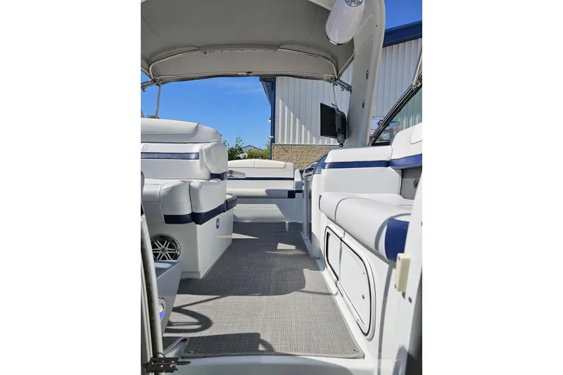 Slide: The Image of 2015 Formula 350 Sun Sport boat interior with white and blue seating under canopy. - 108
