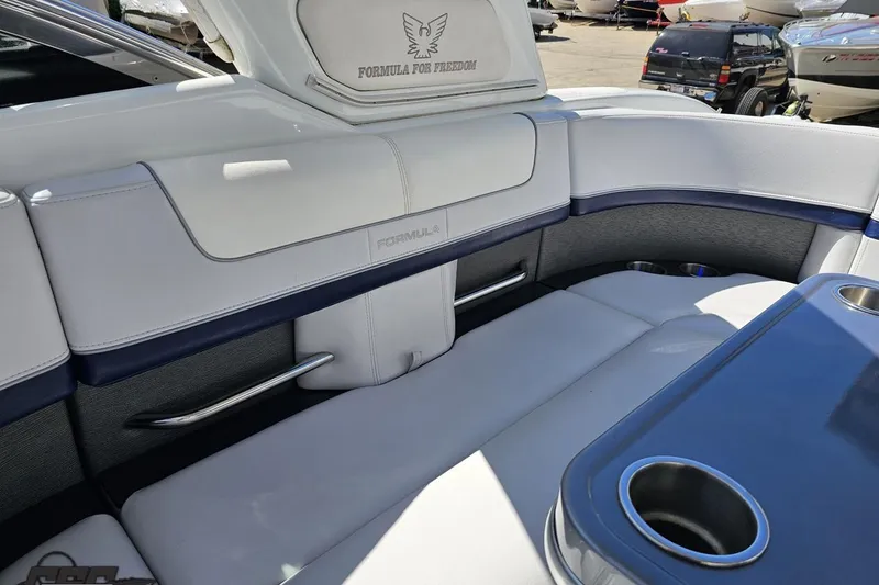 Slide: The Image of Interior of a 2015 Formula 350 Sun Sport boat with white seating and blue table. - 115