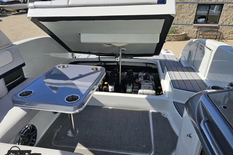 Slide: The Image of 2015 Formula 350 Sun Sport boat engine compartment with open hatch and table. - 118