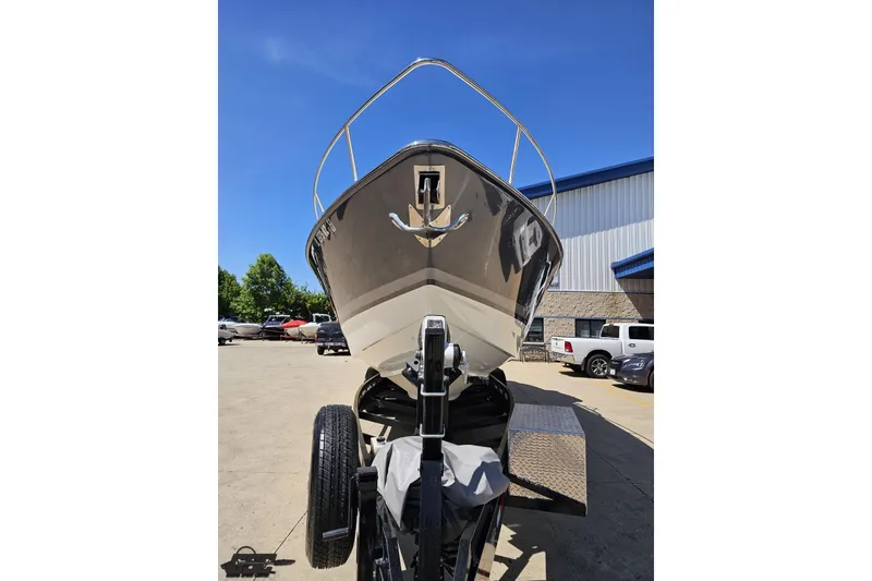 Slide: The Image of 2015 Formula 350 Sun Sport boat on trailer, parked outdoors under clear blue sky. - 16