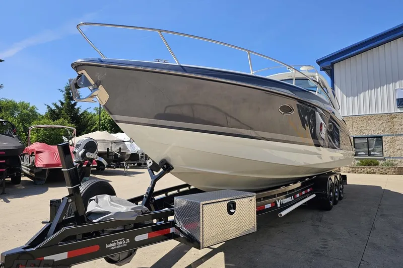 Slide: The Image of 2015 Formula 350 Sun Sport boat on trailer, parked outdoors near a building. - 17