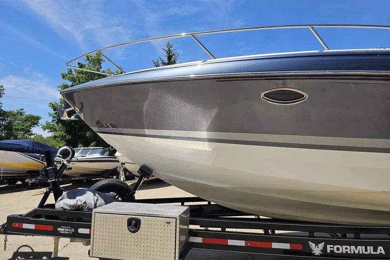Slide: The Image of 2015 Formula 350 Sun Sport boat on trailer under clear blue sky. - 18