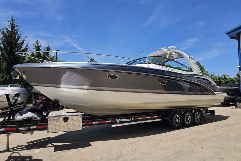 Slide: The Image of 2015 Formula 350 Sun Sport boat on trailer under clear blue sky. - 19