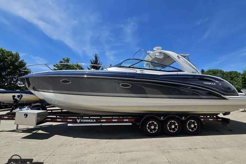 Slide: The Image of 2015 Formula 350 Sun Sport boat on trailer under clear blue sky. - 20