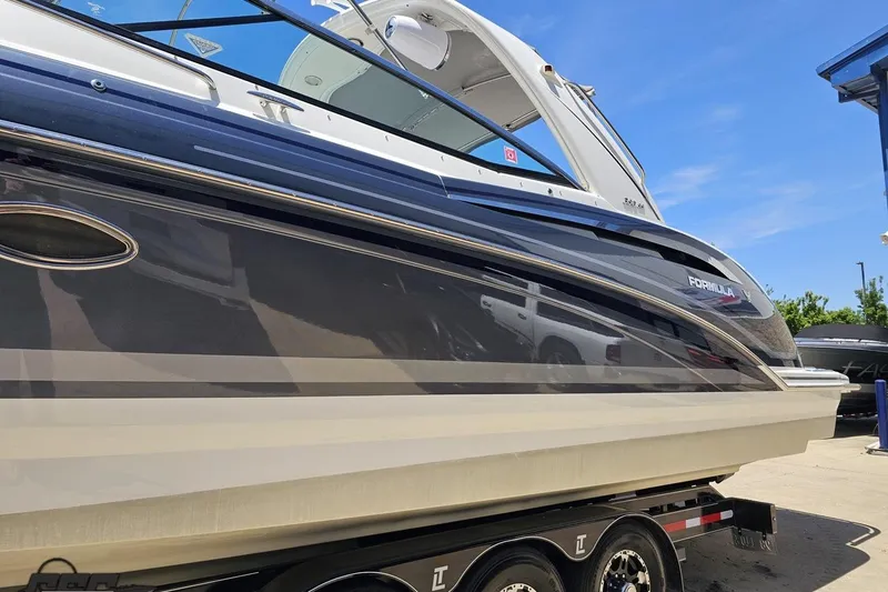 Slide: The Image of 2015 Formula 350 Sun Sport boat on trailer, side view under clear blue sky. - 22