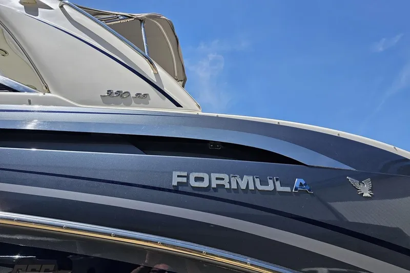 Slide: The Image of 2015 Formula 350 Sun Sport boat with sleek design against blue sky. - 24
