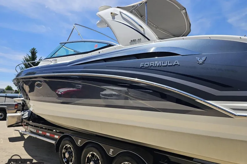 Slide: The Image of 2015 Formula 350 Sun Sport boat on trailer under clear blue sky. - 25