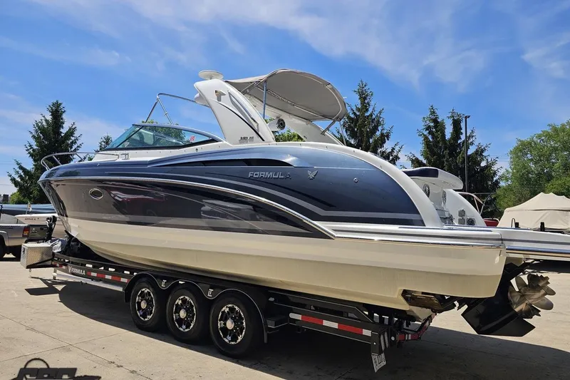 Slide: The Image of 2015 Formula 350 Sun Sport boat on trailer under clear blue sky. - 26