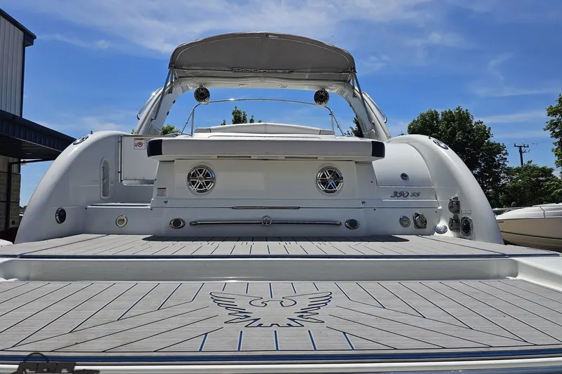 Slide: The Image of 2015 Formula 350 Sun Sport boat with sleek design and spacious deck under clear blue sky. - 30