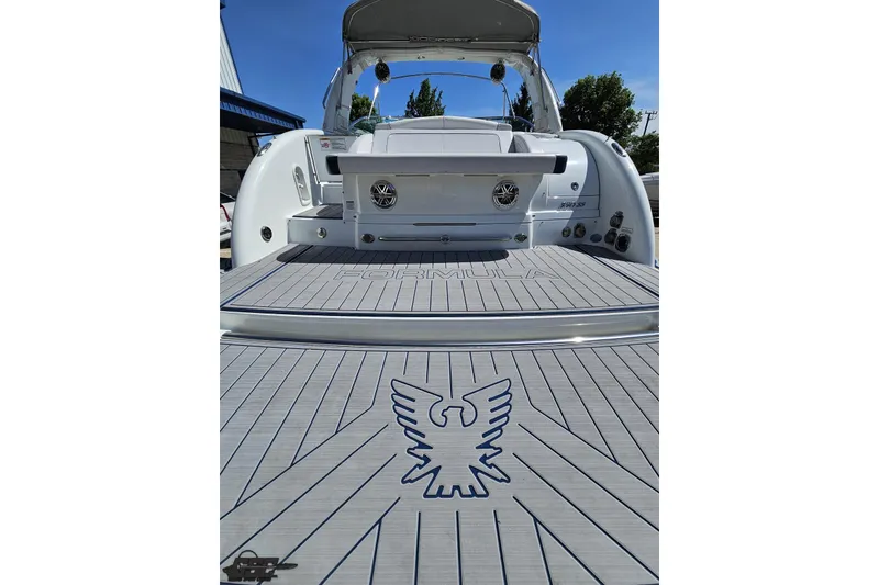 Slide: The Image of 2015 Formula 350 Sun Sport boat with eagle emblem on deck, docked outdoors. - 35