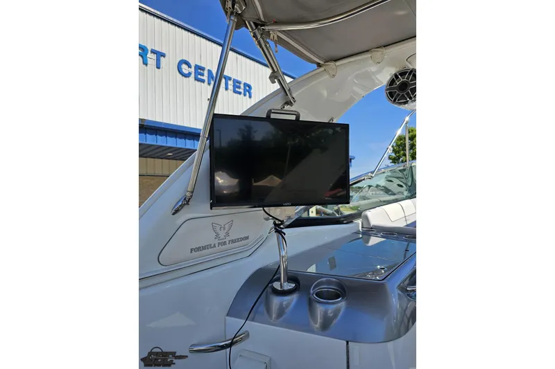 Slide: The Image of 2015 Formula 350 Sun Sport boat with mounted TV screen and cup holders. - 49