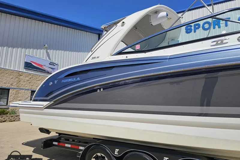 Slide: The Image of 2015 Formula 350 Sun Sport boat displayed outside a showroom on a trailer. - 5