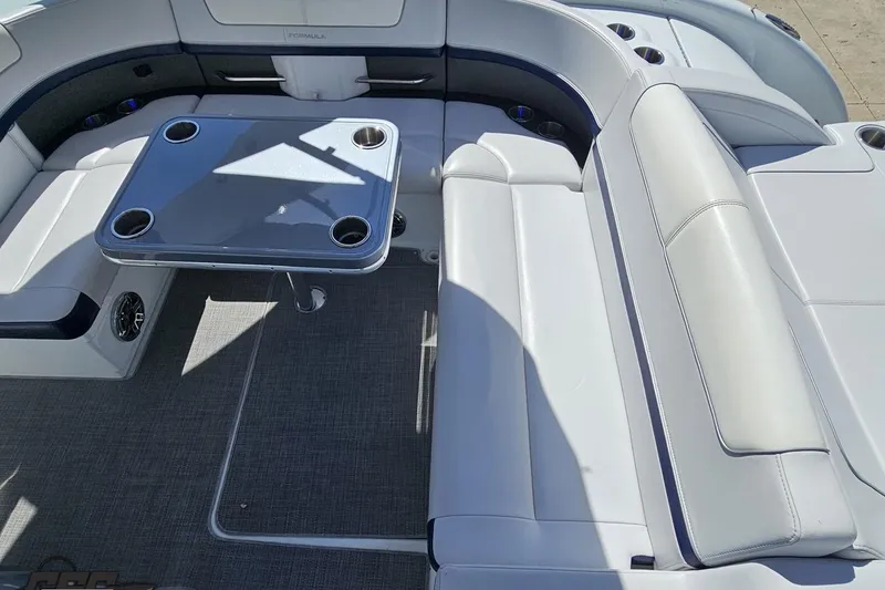 Slide: The Image of Spacious seating area on a 2015 Formula 350 Sun Sport boat with table and cup holders. - 55