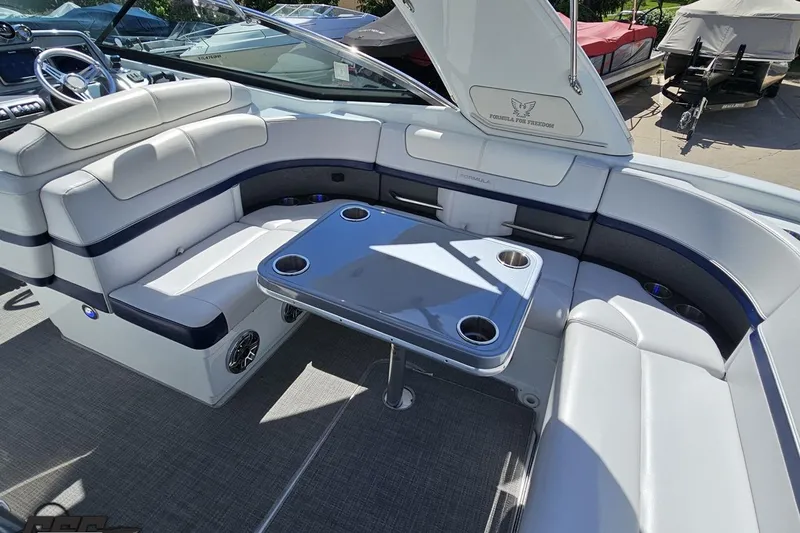 Slide: The Image of Luxurious seating area on a 2015 Formula 350 Sun Sport boat with table and cup holders. - 56