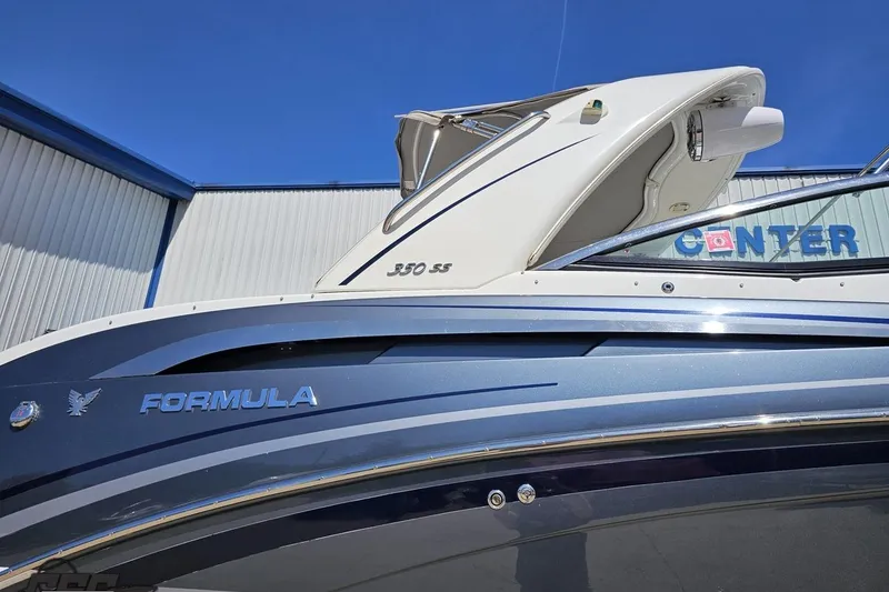 Slide: The Image of 2015 Formula 350 Sun Sport boat exterior with sleek design and branding. - 6