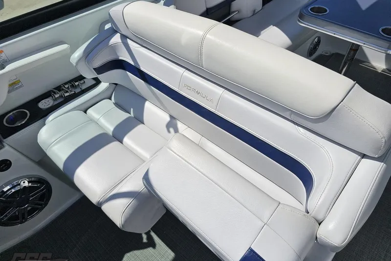 Slide: The Image of Luxurious seating on a 2015 Formula 350 Sun Sport boat, featuring sleek white and blue upholstery. - 67