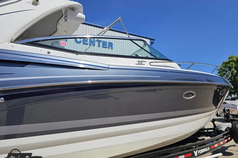 Slide: The Image of 2015 Formula 350 Sun Sport boat on trailer, blue and white exterior, sunny day. - 7