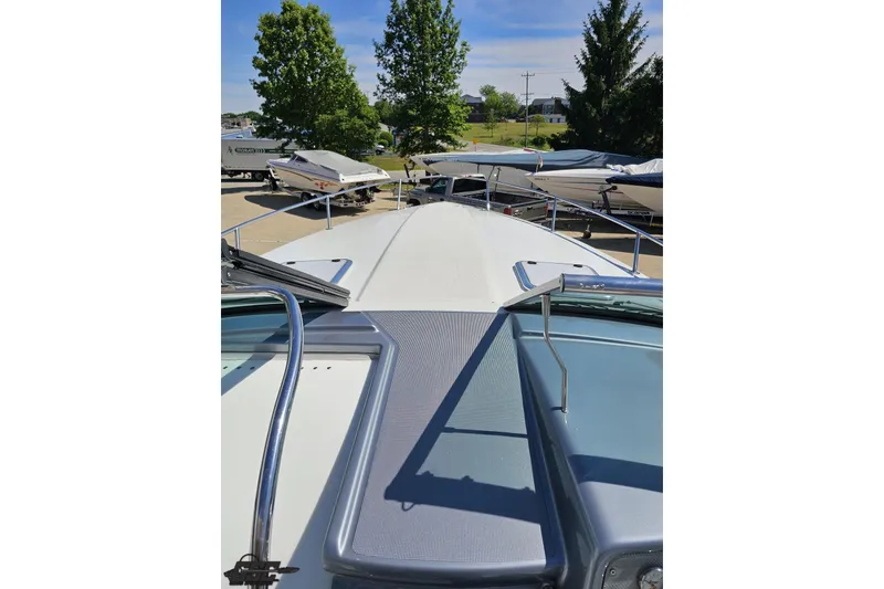Slide: The Image of 2015 Formula 350 Sun Sport boat deck view with surrounding boats and trees. - 75