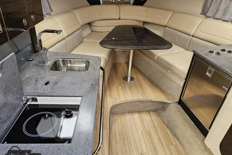 Slide: The Image of Luxurious interior of a 2015 Formula 350 Sun Sport boat with kitchenette and seating area. - 83