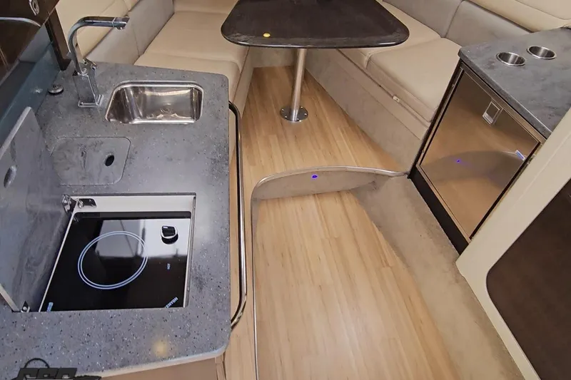 Slide: The Image of Interior of 2015 Formula 350 Sun Sport boat with kitchenette and seating area. - 84