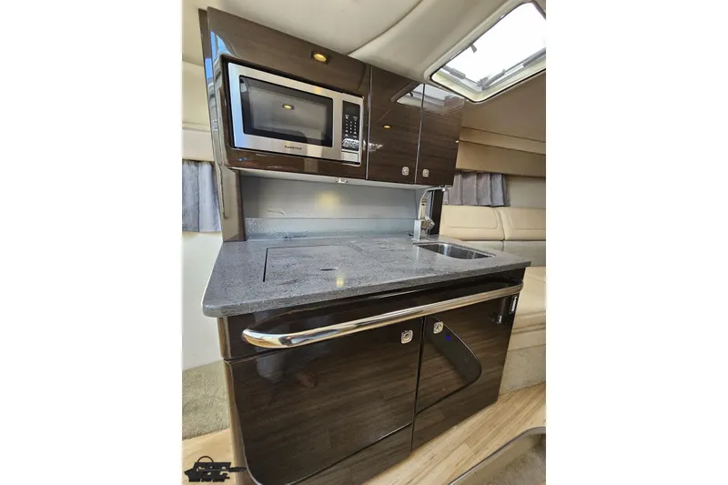 Slide: The Image of 2015 Formula 350 Sun Sport yacht interior kitchen with microwave and sleek cabinetry. - 89