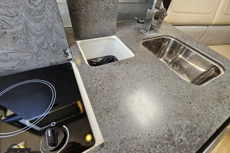 Slide: The Image of 2015 Formula 350 Sun Sport kitchen area with sleek countertop, sink, and stove. - 91