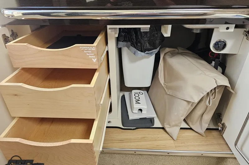 Slide: The Image of Interior storage of 2015 Formula 350 Sun Sport boat with wooden drawers and organized compartments. - 93