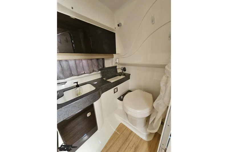 Slide: The Image of 2015 Formula 350 Sun Sport bathroom with modern sink, toilet, and storage cabinets. - 97