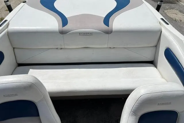 Slide: The Image of 2005 Stingray 180 RX boat interior with white and blue seating. - 2