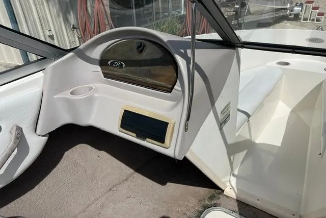 Slide: The Image of 2005 Stingray 180 RX boat interior dashboard with steering wheel and seating area. - 5