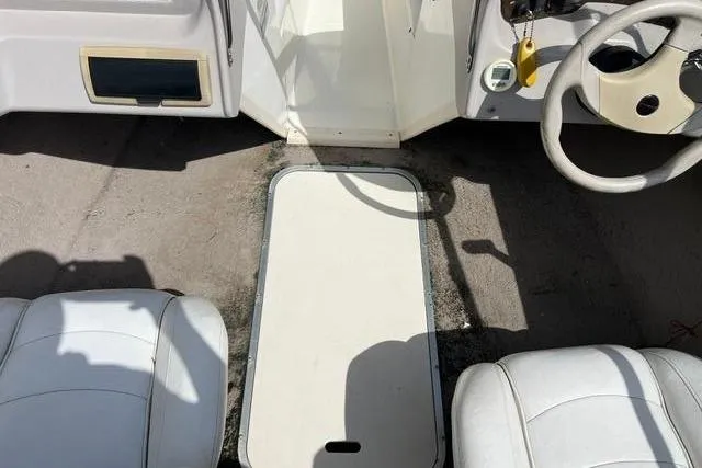 Slide: The Image of Interior of a 2005 Stingray 180 RX boat with white seats. - 8