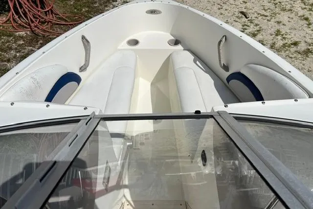 Slide: The Image of 2005 Stingray 180 RX boat interior with white seating and blue accents. - 9
