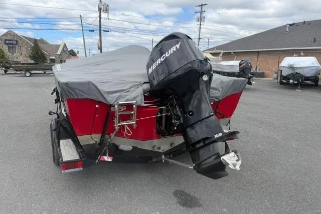 Slide: The Image of 2011 Tracker Pro Guide V-175 SC boat with Mercury outboard motor, covered and parked outdoors. - 10